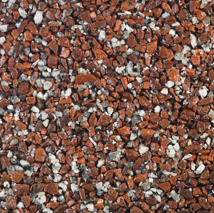 Close-up of a surface covered with small, red and white gravel.