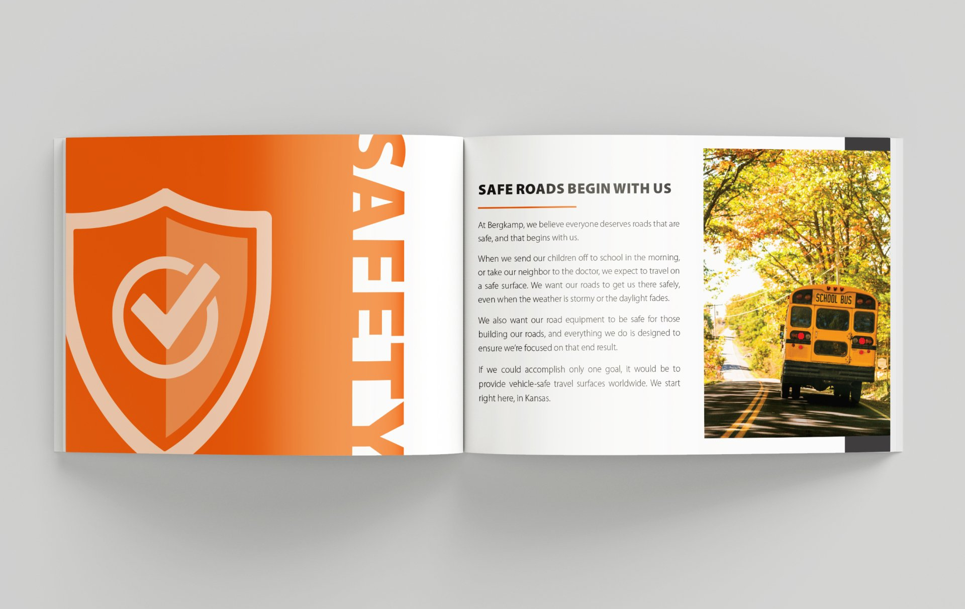 A book is open to a page with a picture of a school bus on the road.