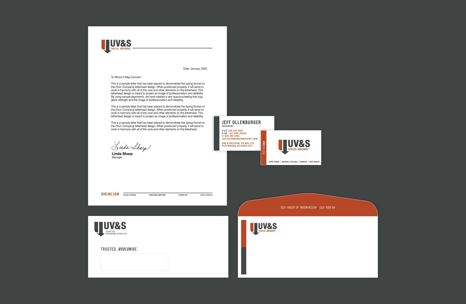 Two business cards are stacked on top of each other on a wooden table.