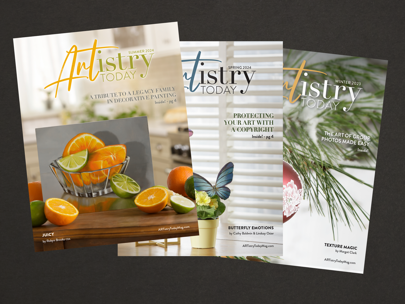 Three magazines are sitting on top of each other on a table.