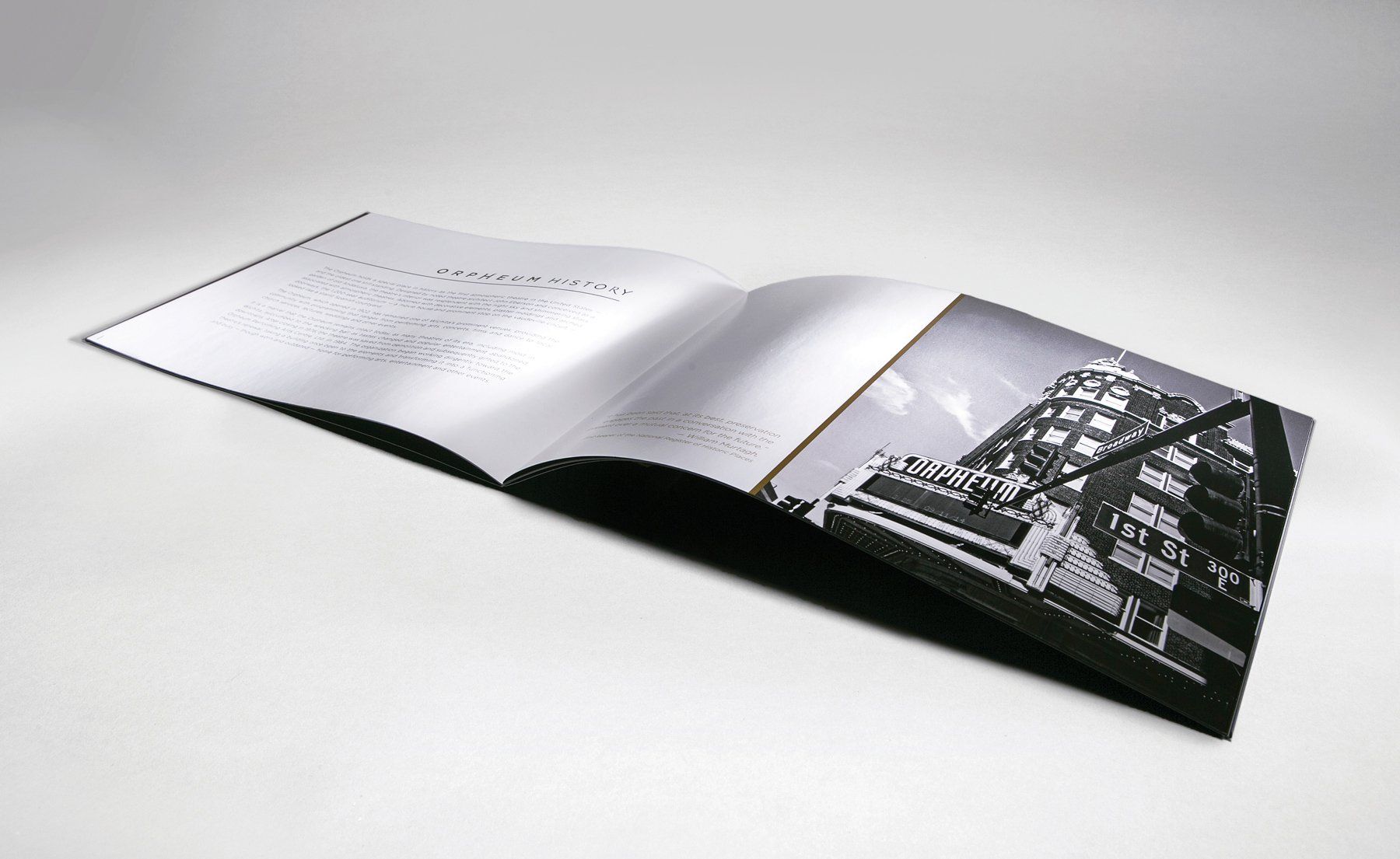 A book is open to a page with a picture of a building on it