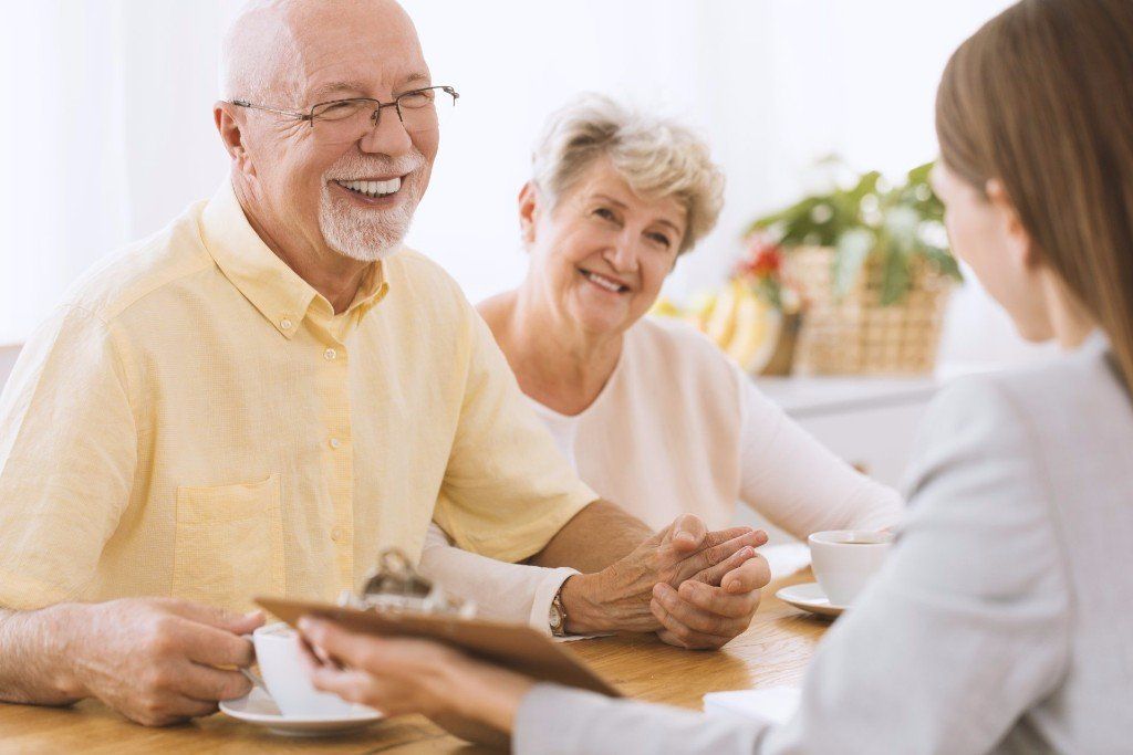 Elders - Elder Couple Smiling Happily In Front of a Woman in Belvidere, NJ