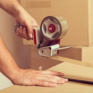 Commercial Movers — Guy's hands holding packing Machine in Jacksonville, FL