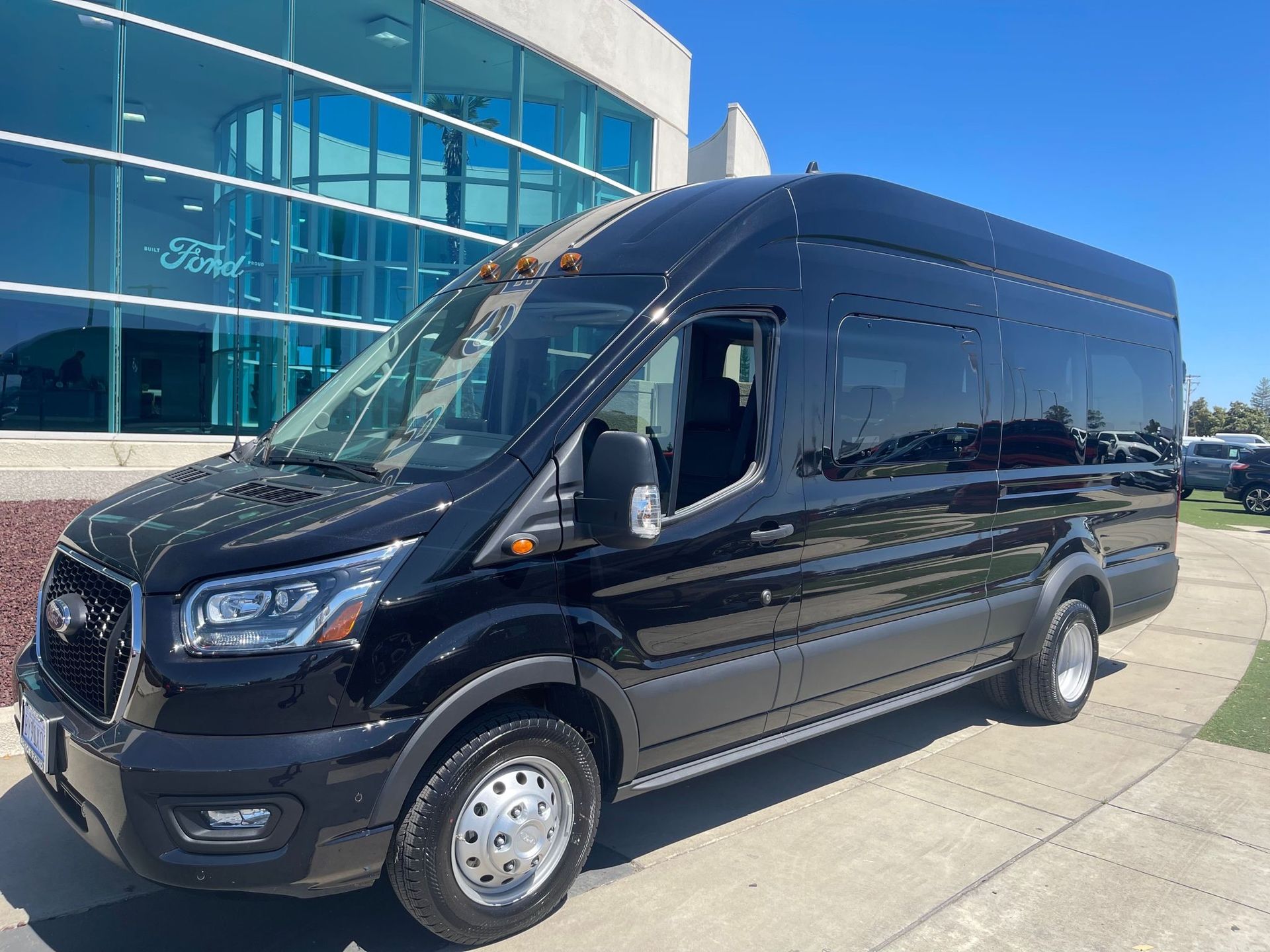 The inside of a bus with black seats and a table
