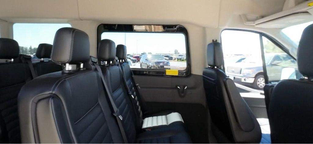 The inside of a van with a lot of seats and a window.