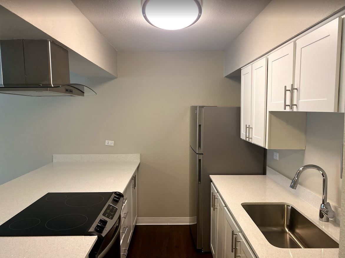 Modern kitchen with stainless steel appliances and white cabinetry