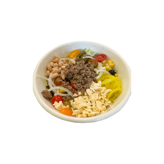 Salad bowl with various ingredients: beans, meat, tomatoes, corn, and peppers.