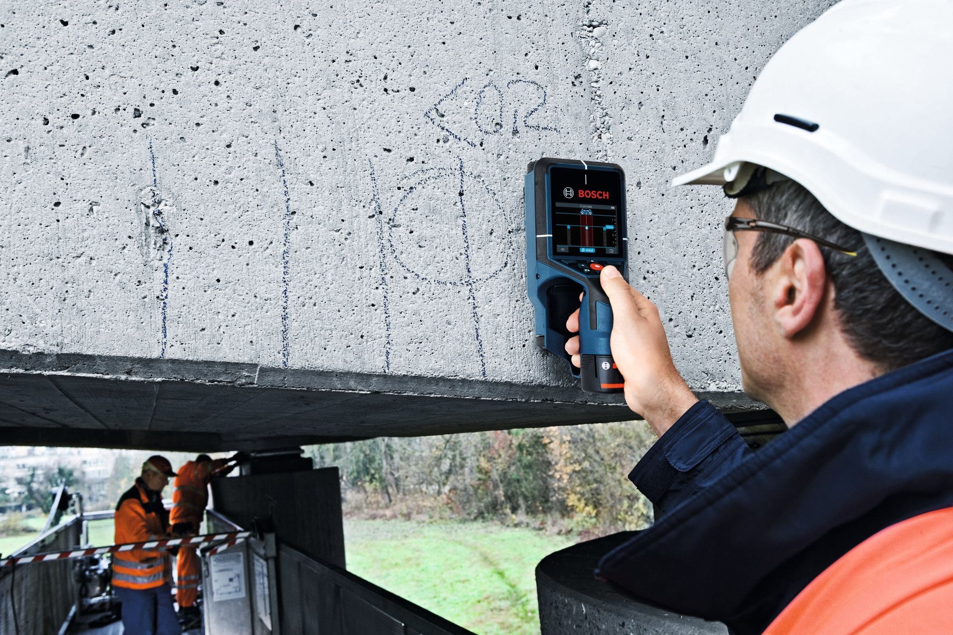 a large excavator is demolishing a house in the middle of a forest .