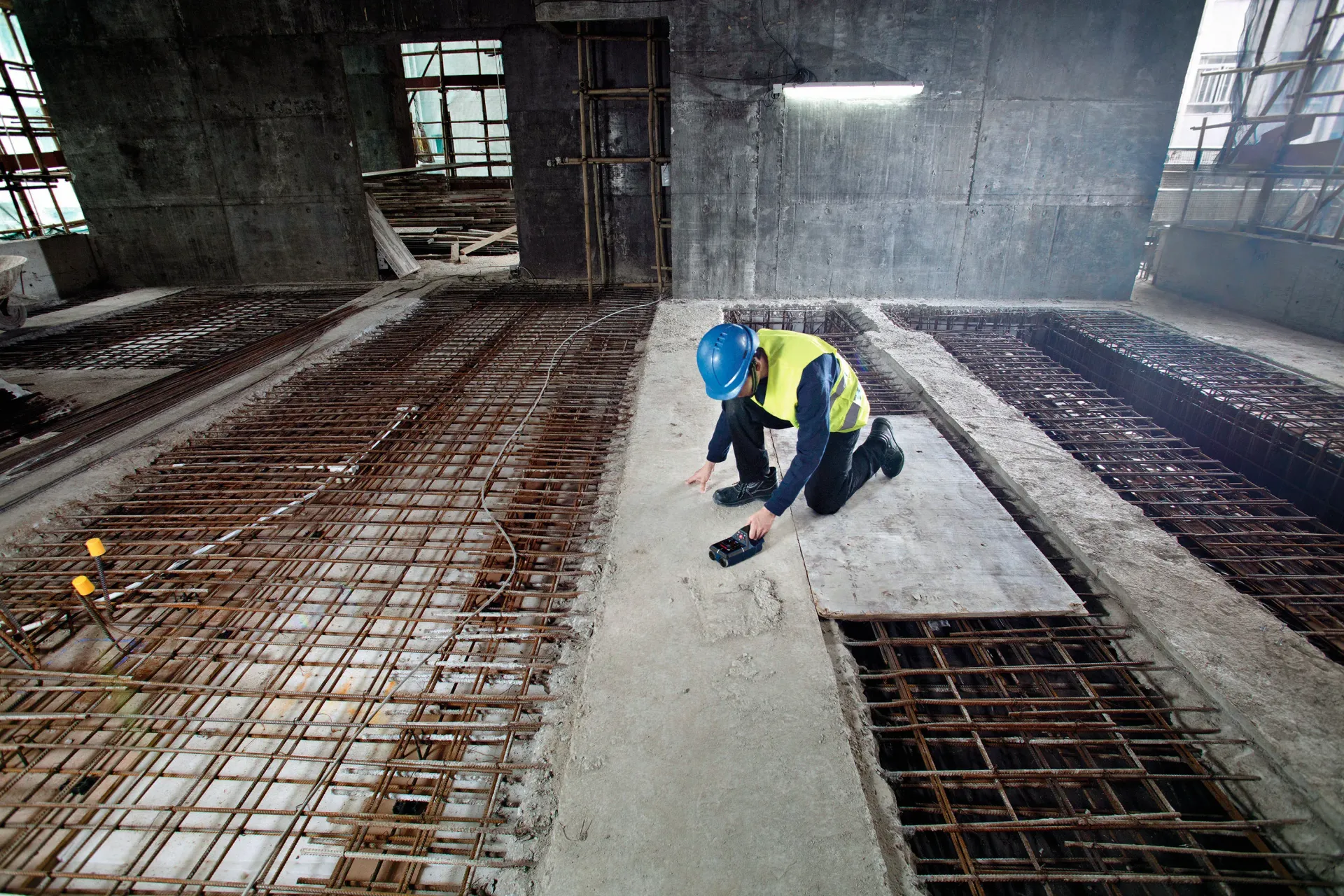 A large house is being demolished by a bulldozer.