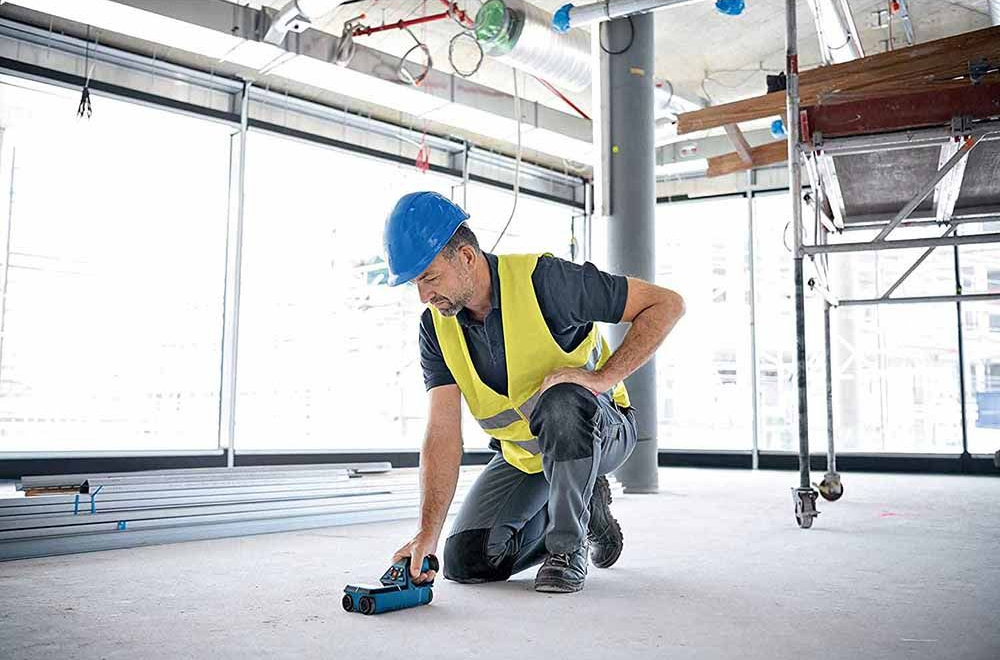 A large excavator is demolishing a house.