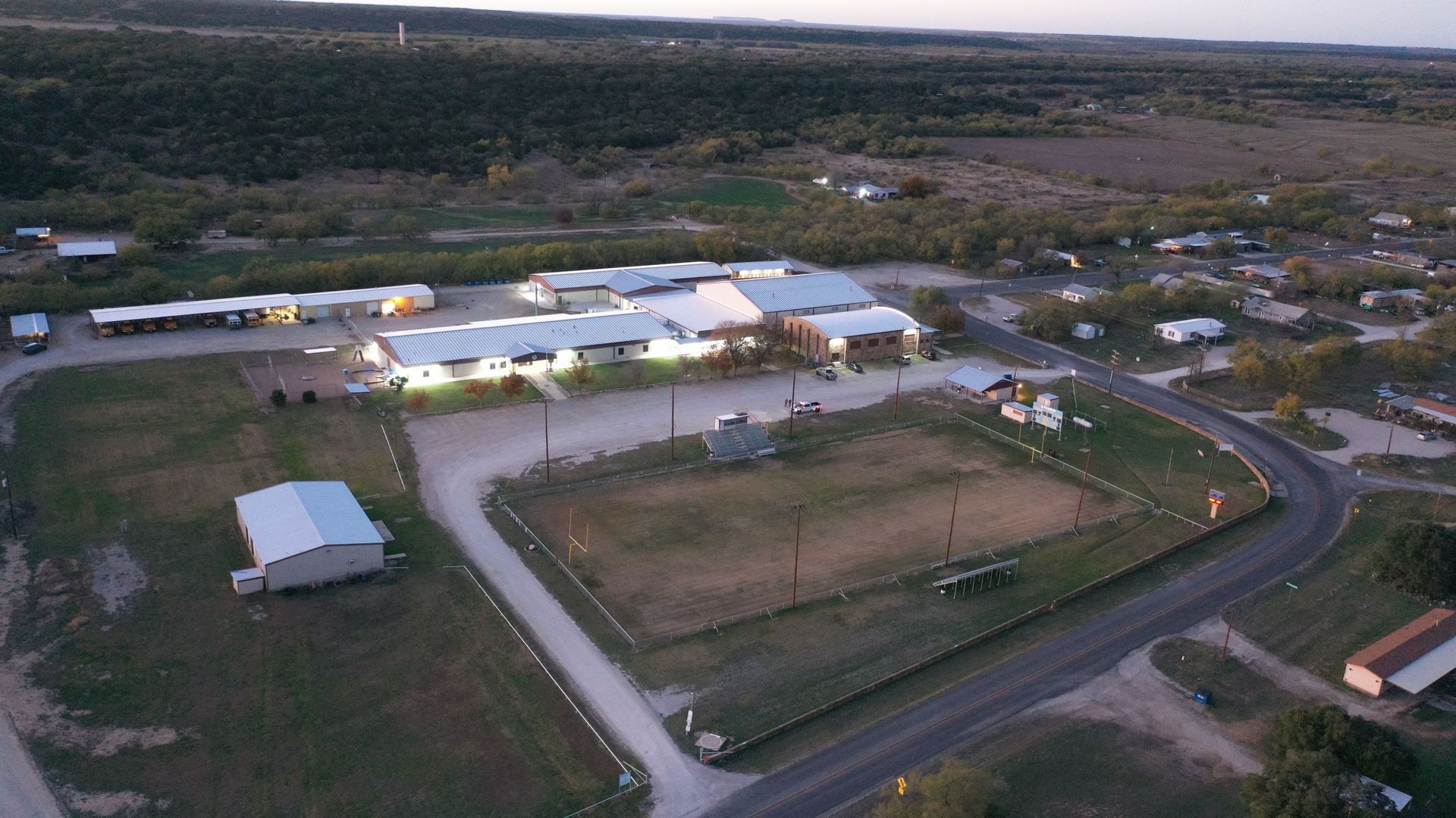 two construction workers are standing in front of a pile of scrap metal .