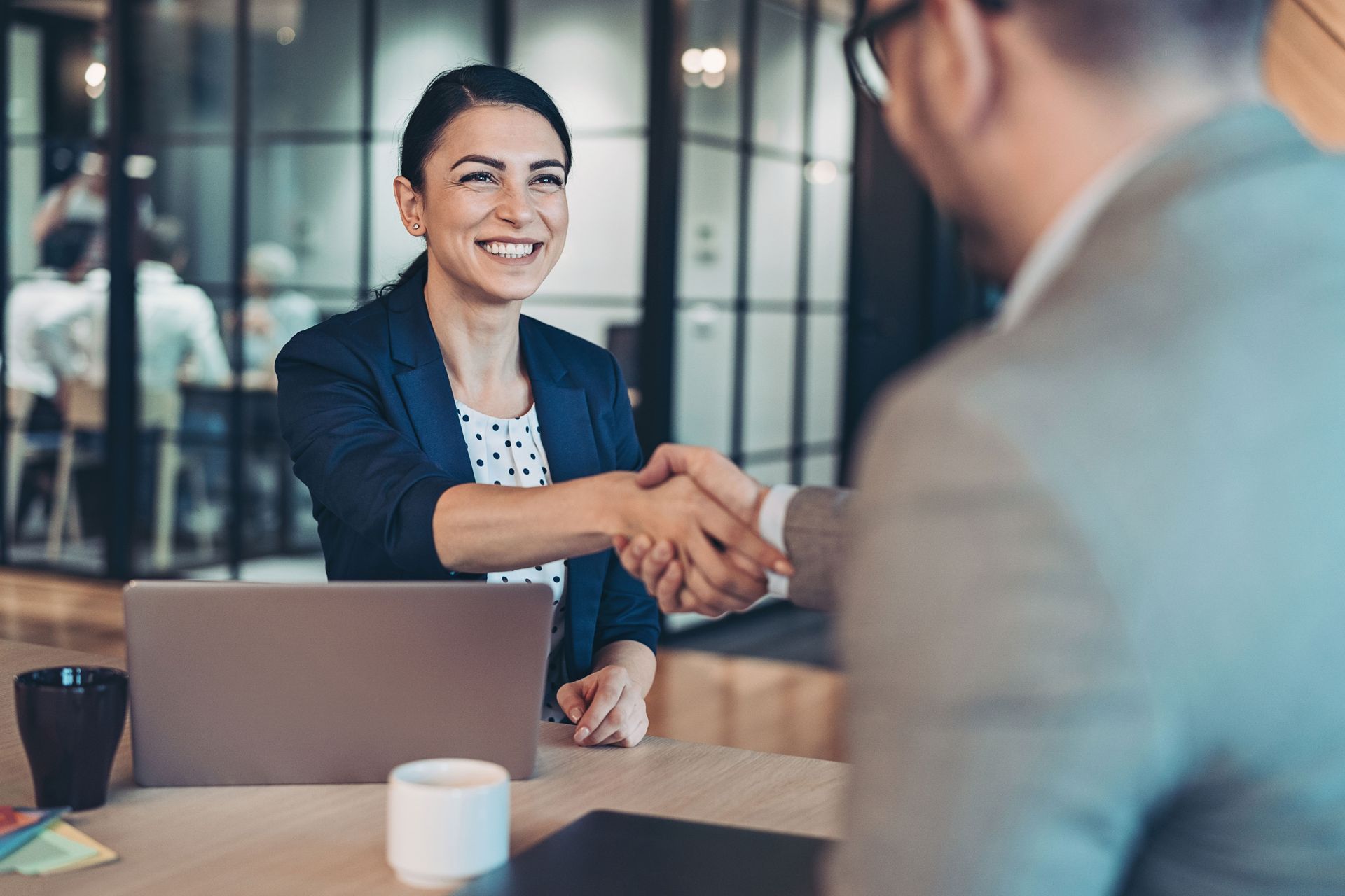 A Man And A Woman Shaking Hands — The Law Offices Of Cardaro & Peek, LLC