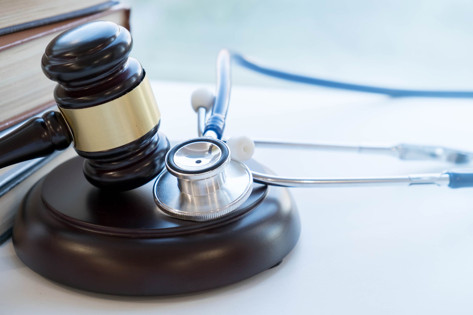 A judge 's gavel is sitting in front of a scale of justice.
