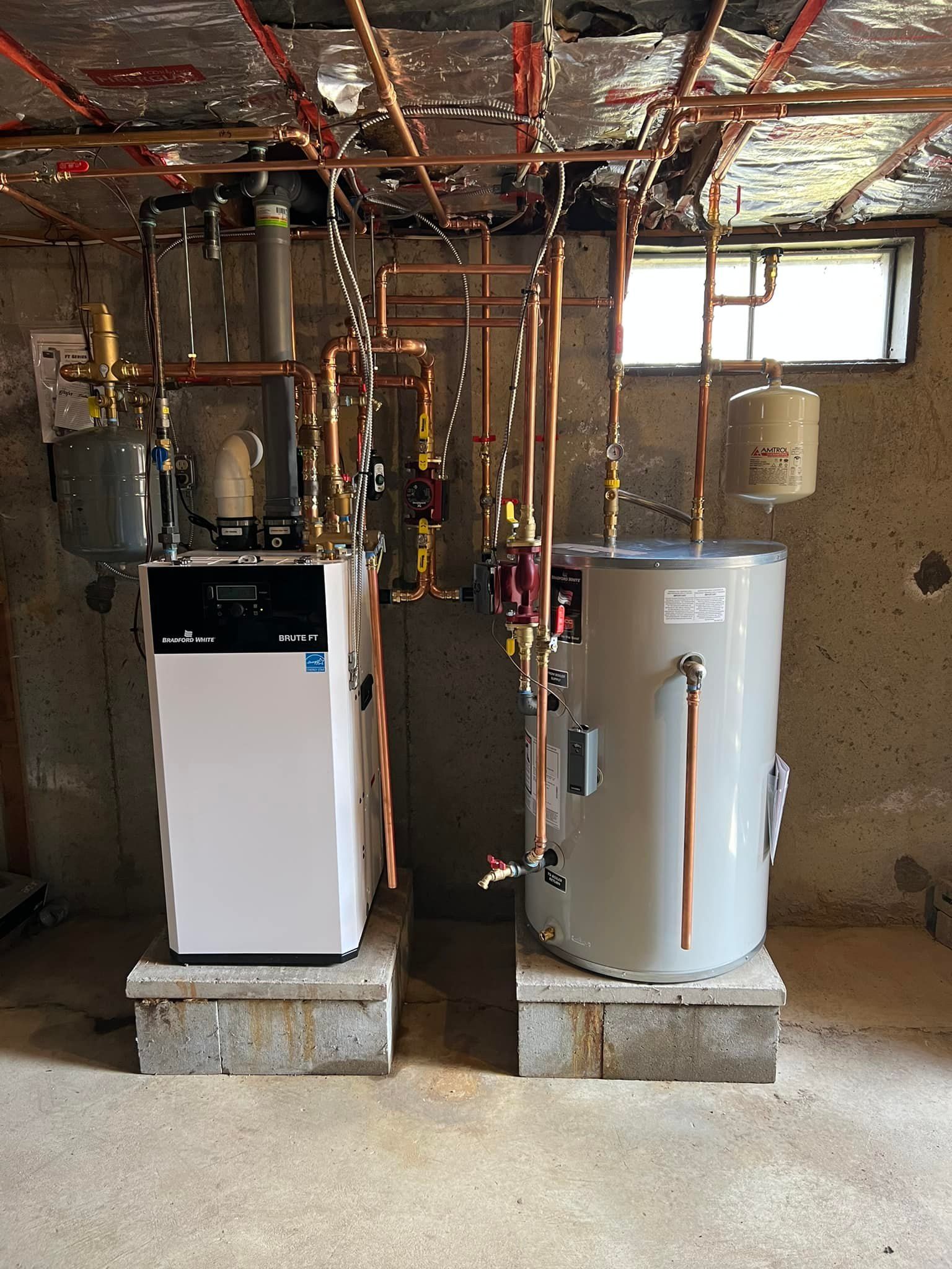 A basement with a water heater , sink , and shelves. A basement with a water heater , sink , and shelves.