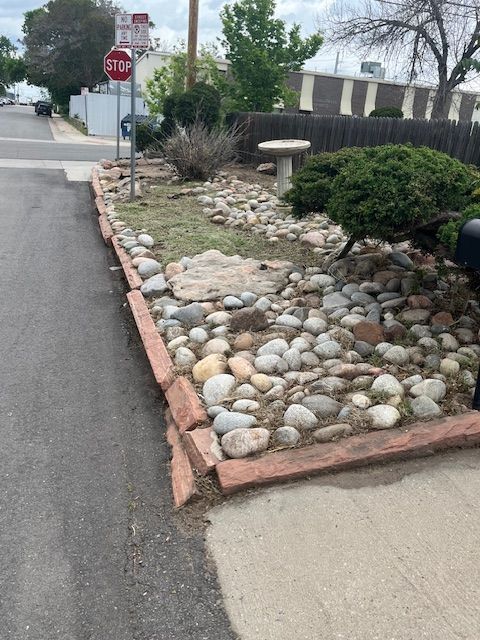 A stop sign is next to a rock garden