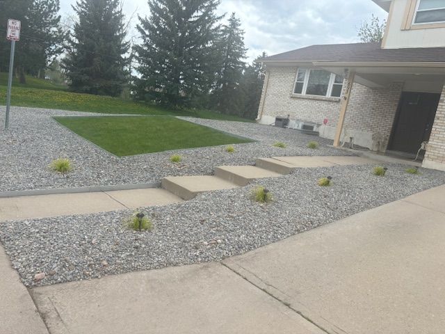 A house with a gravel driveway and steps in front of it