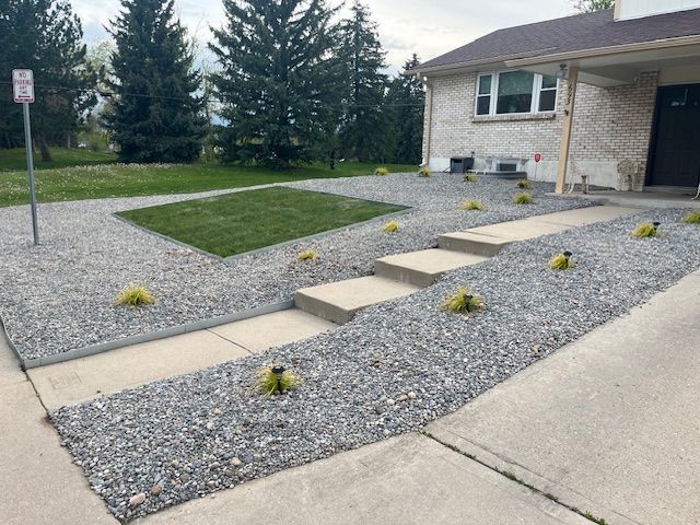 A brick house with a gravel driveway in front of it