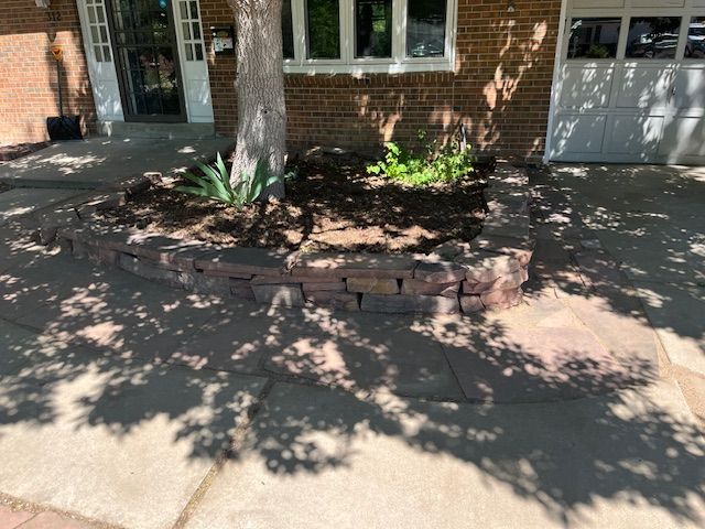 A brick house with a garden in front of it.