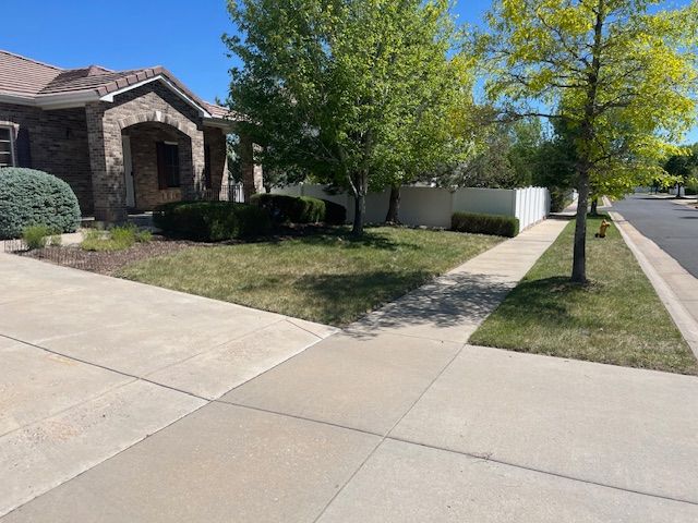 A house with a lawn and a sidewalk in front of it