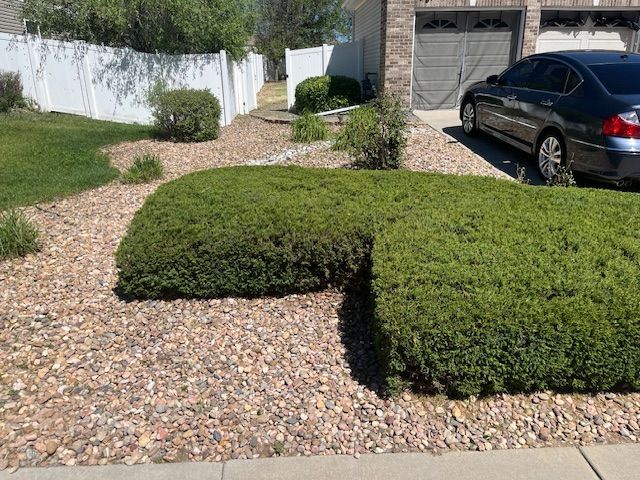 A car is parked in the driveway of a house.
