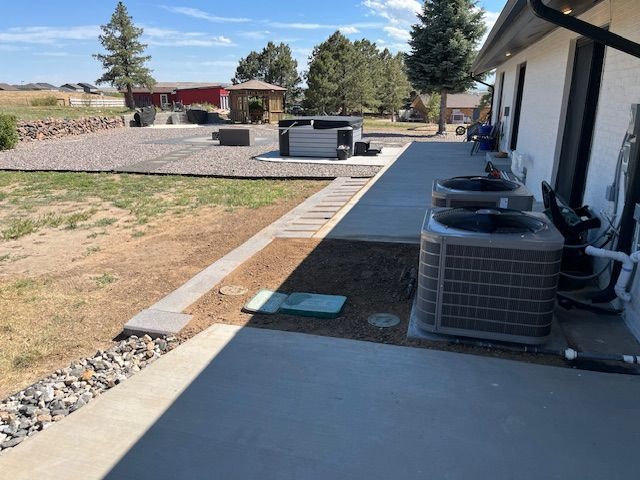 A house with two air conditioners on the side of it