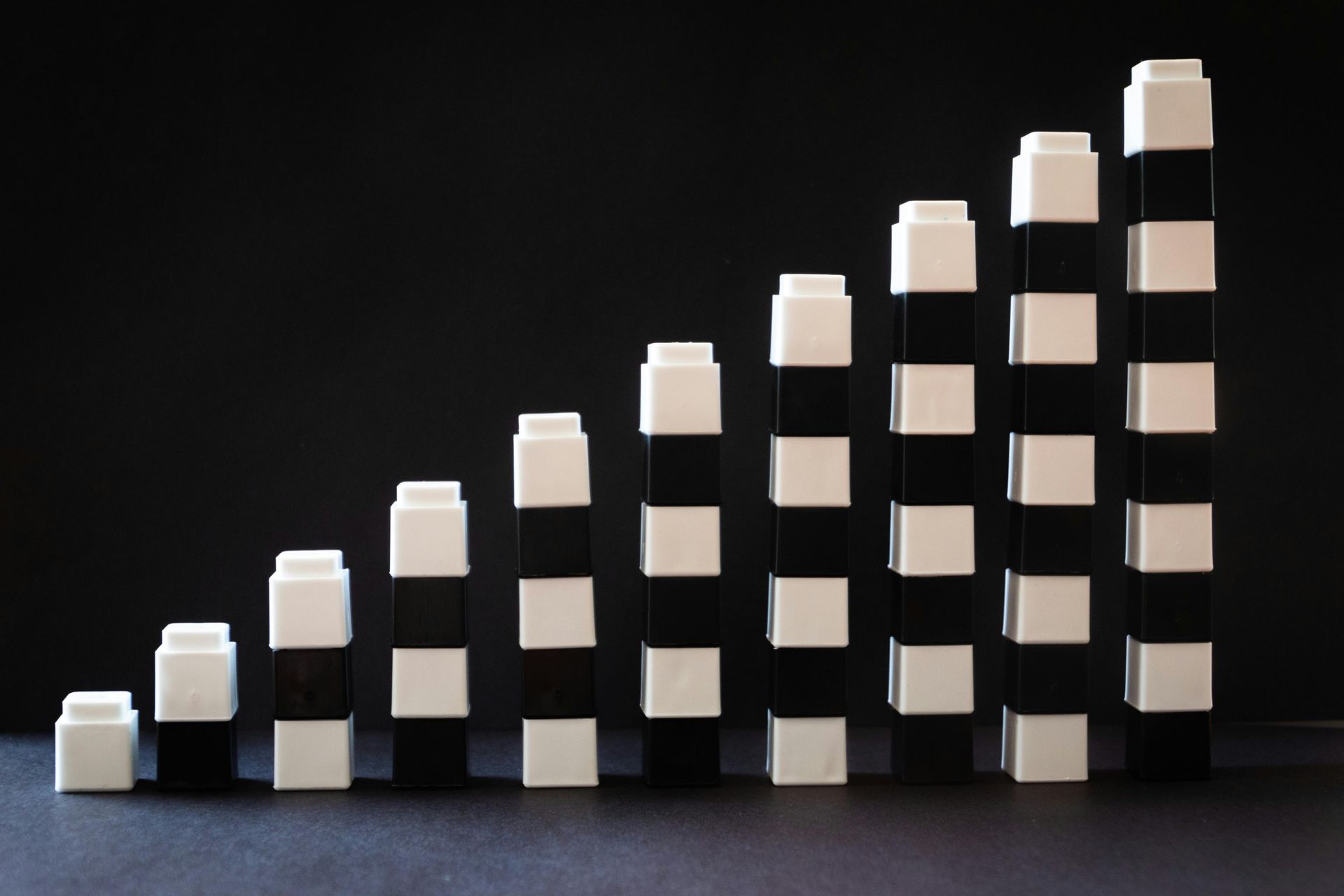 A row of black and white blocks stacked on top of each other. Height increases as you move towards the right.