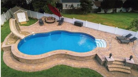 An aerial view of a large swimming pool in a backyard.