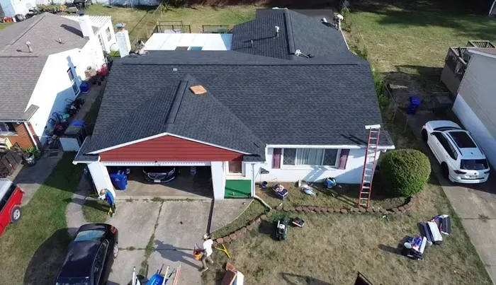 An aerial view of a house with a new roof being installed.