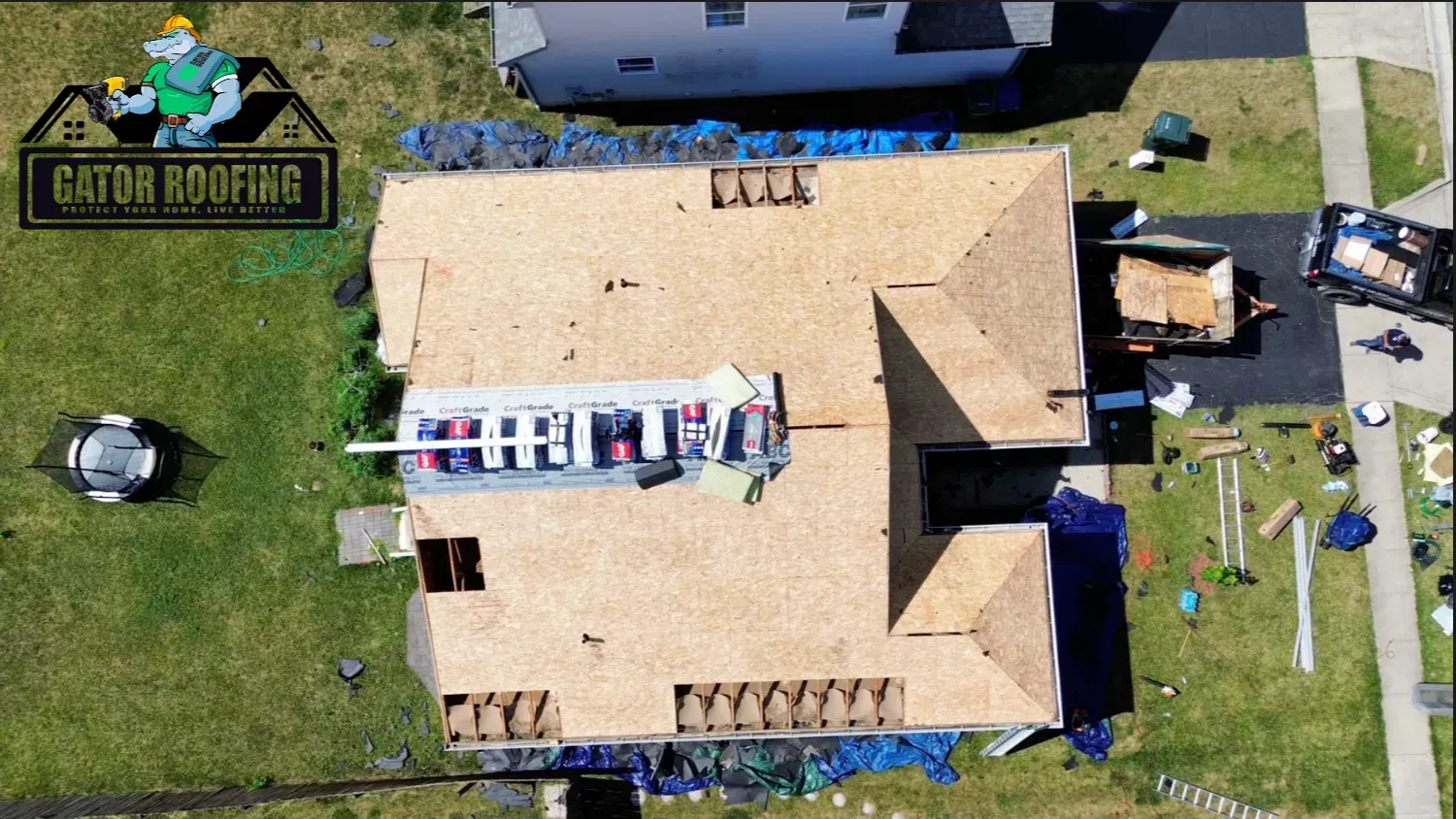 An aerial view of a house being roofed by Gator Roofing