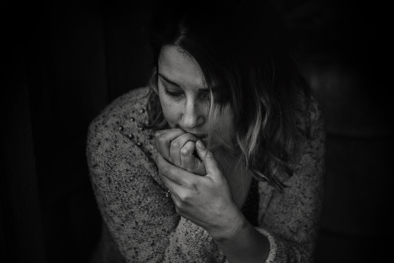 An anxious woman biting her nails