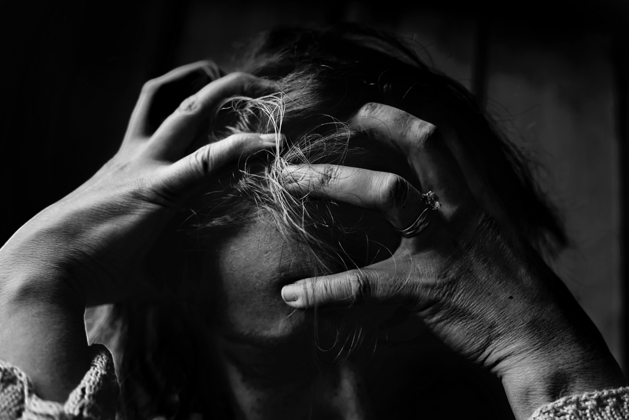 Woman stressed holding her head