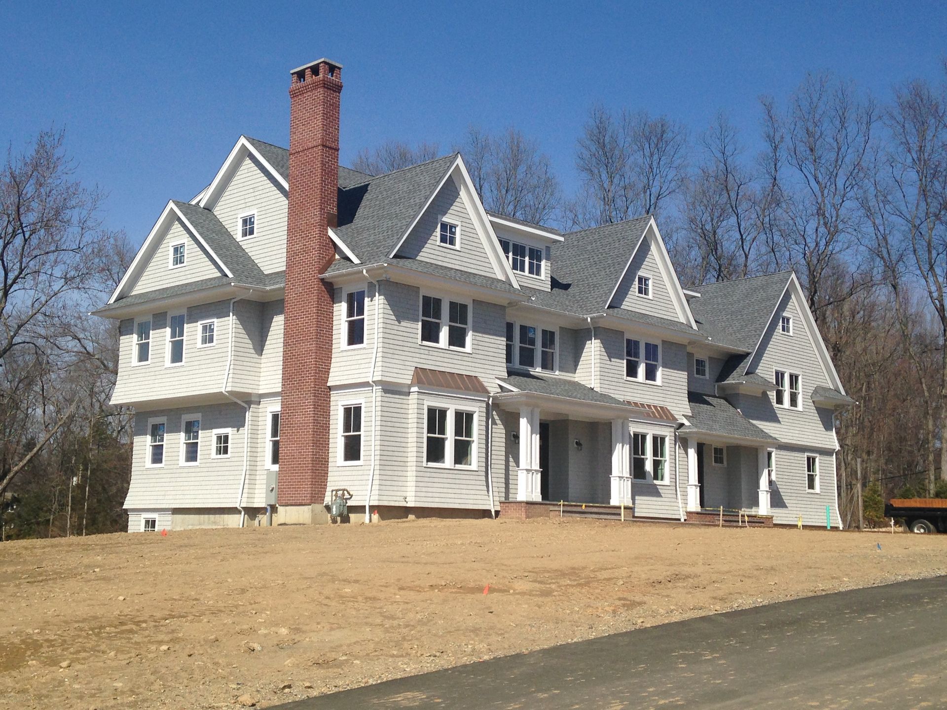 A large white house with a brick chimney