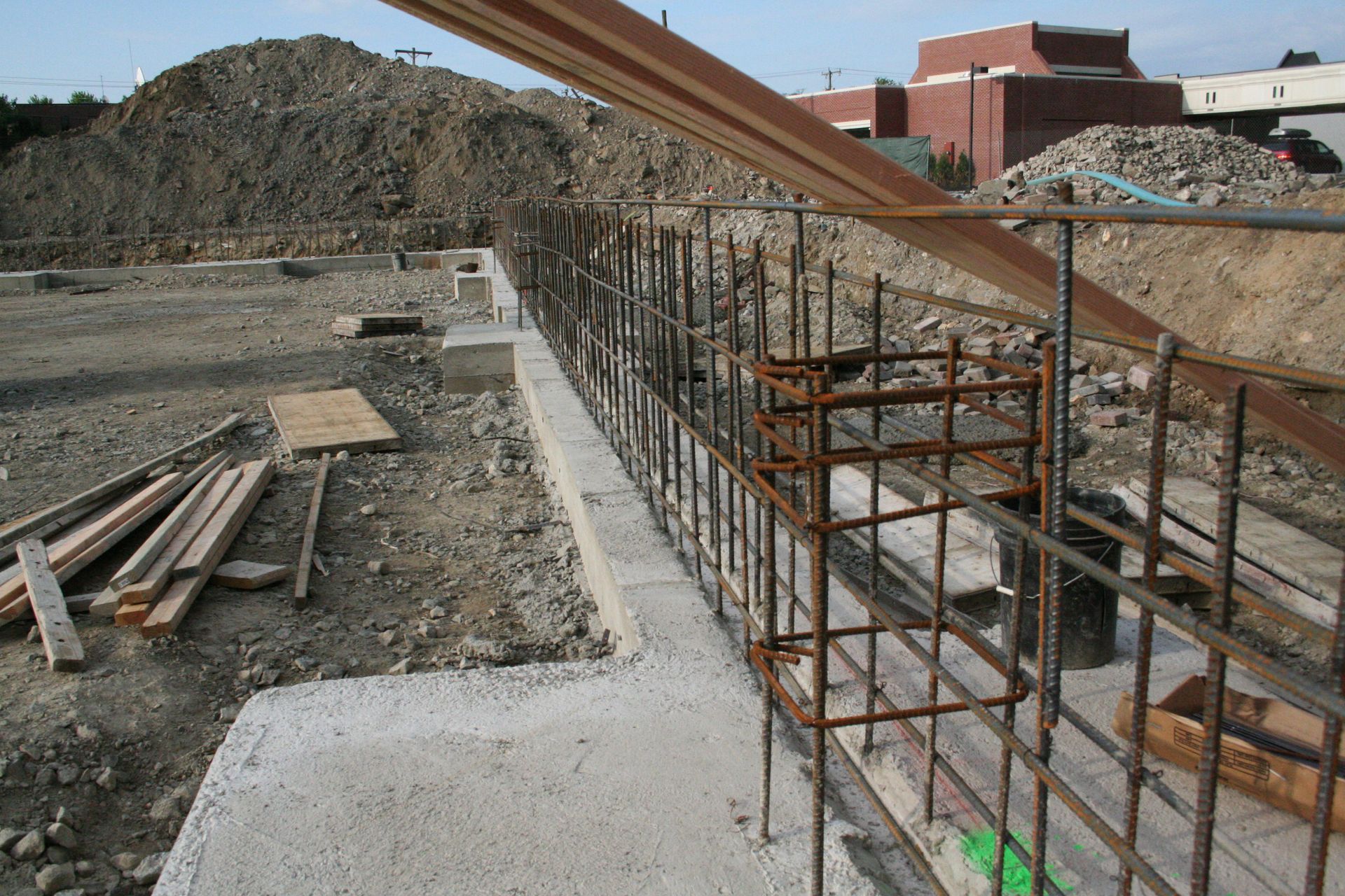 A construction site with a large pile of dirt in the background