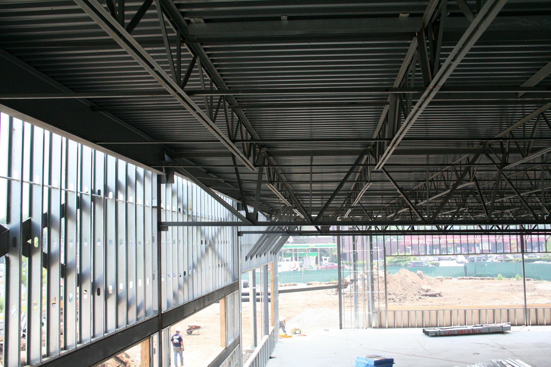The ceiling of a building under construction with a lot of metal beams.