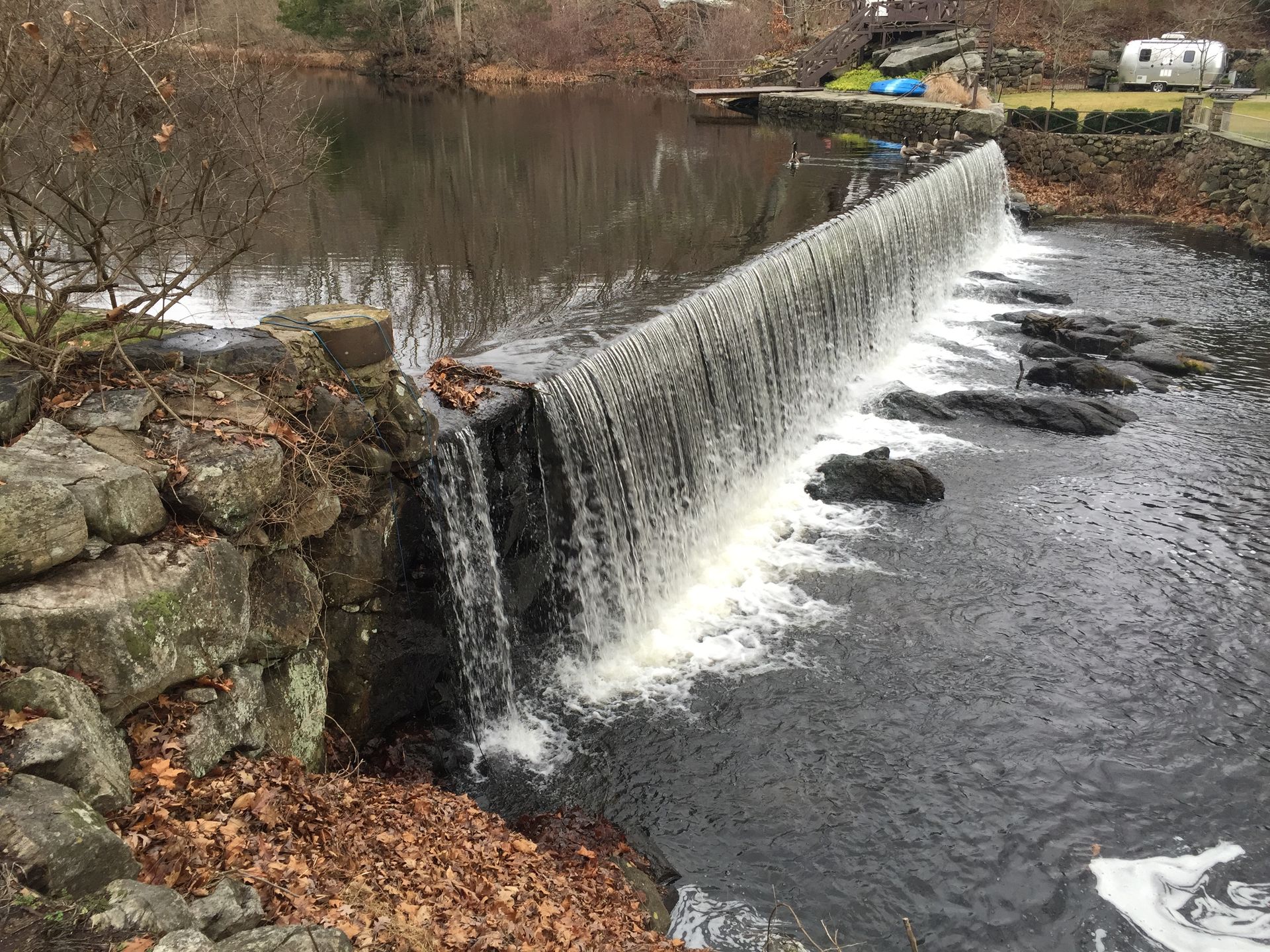 There is a waterfall in the middle of a river.