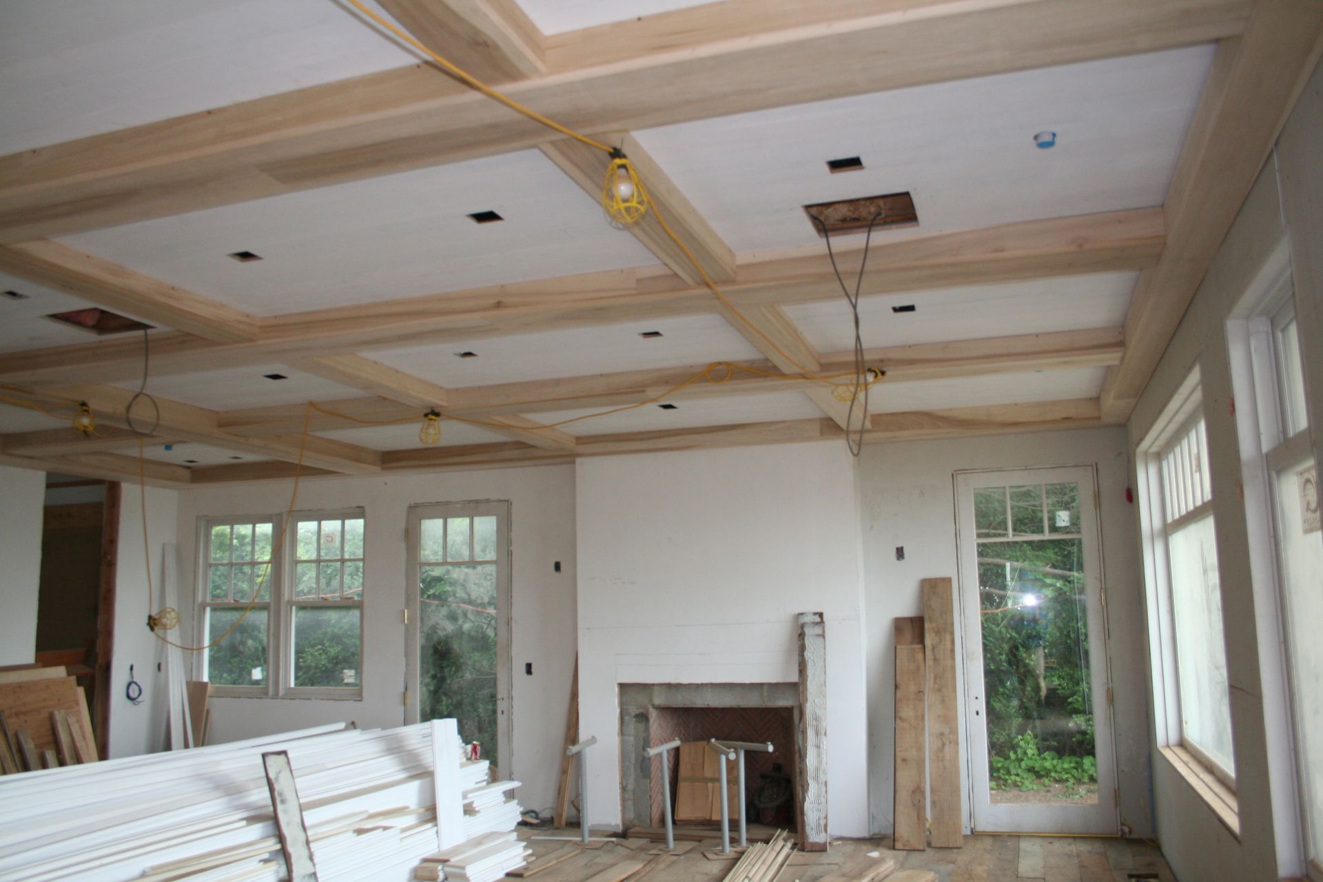 A large room with a fireplace and lots of windows