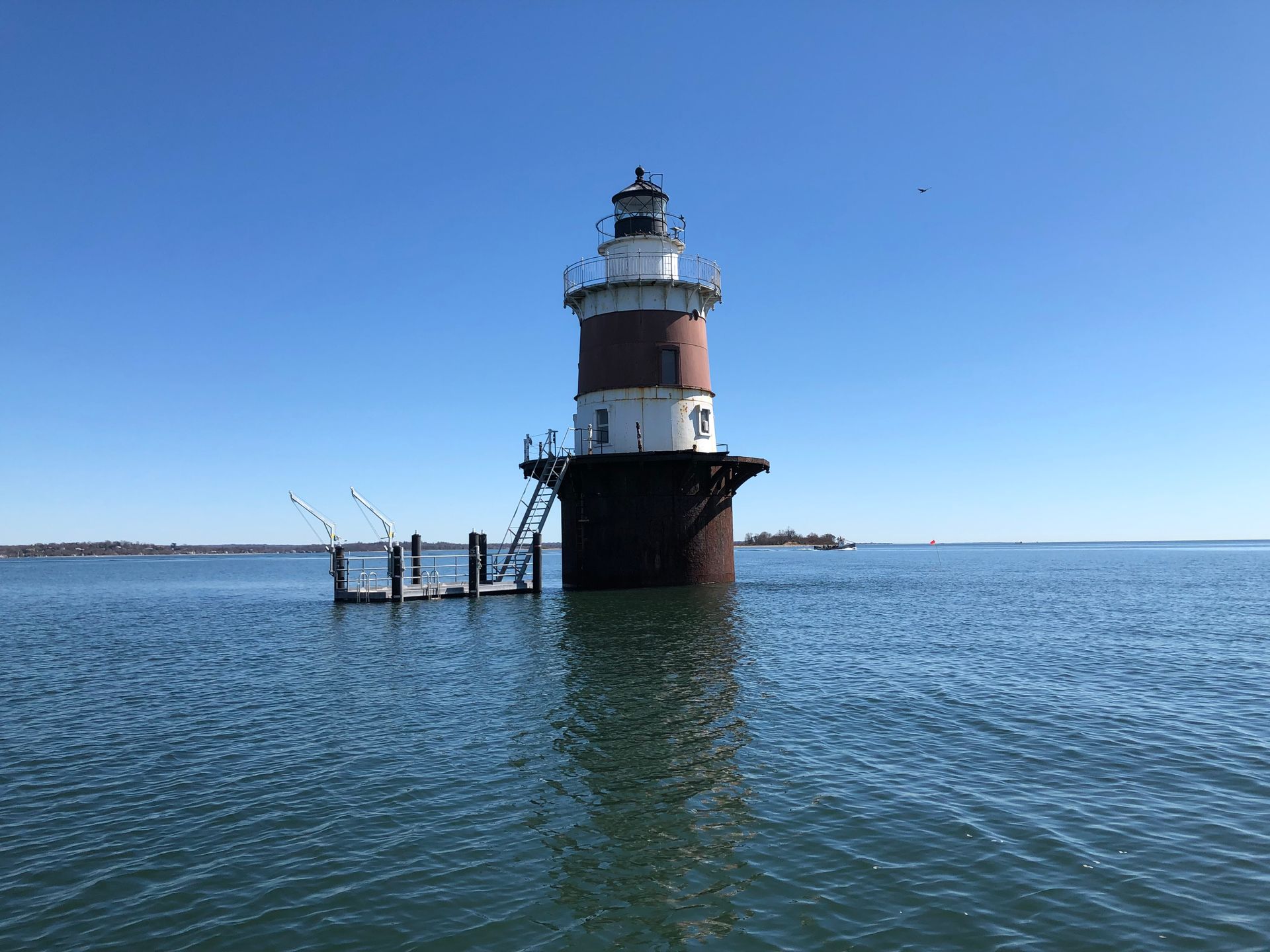 A lighthouse in the middle of a body of water