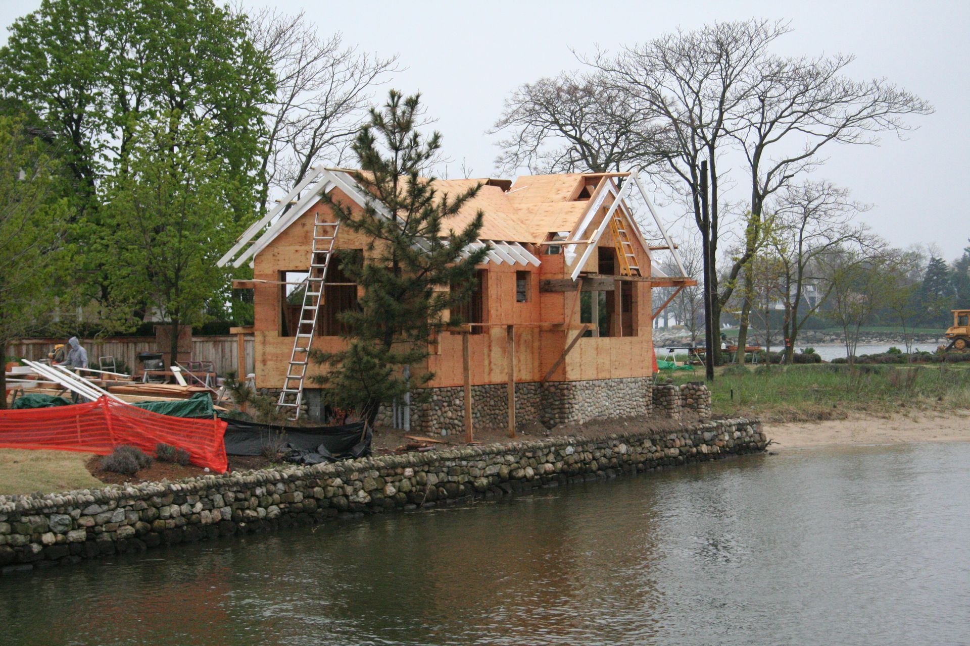 A house is being built next to a body of water
