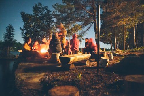 group of friends around a camp fire