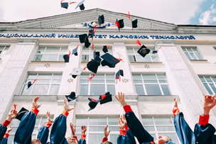 graduates throwing their graduation hats into the air