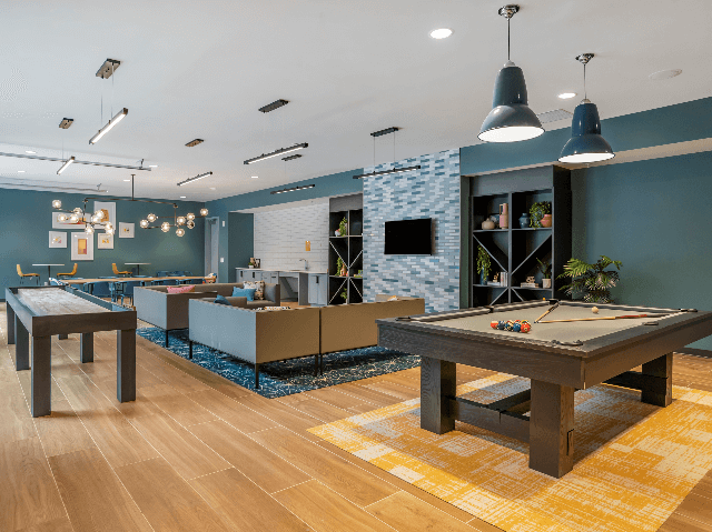 Uncommon Auburn Student Apartment Community Game Lounge with Billiard Table and Shuffleboard.