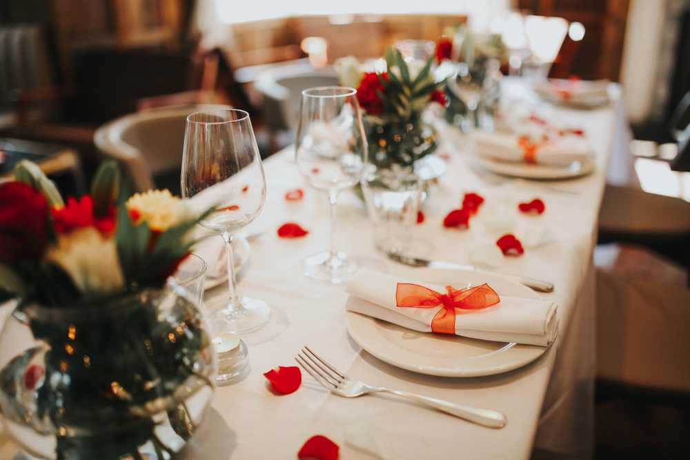 Sparkling glassware stands on long table prepared for wedding dinner