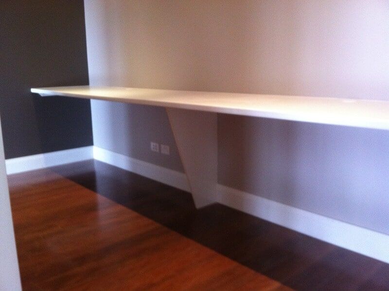 An Empty Room with A Wooden Floor and A Shelf on The Wall — Burns Custom Kitchens in Newcastle, NSW