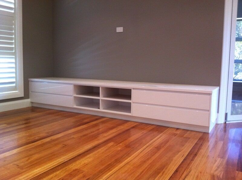 A Living Room with Hardwood Floors and A White Entertainment Center — Burns Custom Kitchens in Newcastle, NSW