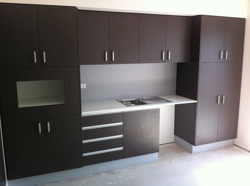 A Kitchen with Brown Cabinets and White Counter Tops — Burns Custom Kitchens in Newcastle, NSW