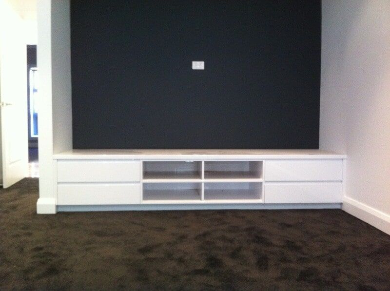 An Empty Room with A Black Wall and A White Entertainment Center — Burns Custom Kitchens in Newcastle, NSW