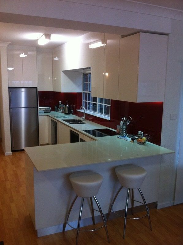 A Kitchen with White Cabinets and A Stainless Steel Refrigerator — Burns Custom Kitchens in Newcastle, NSW