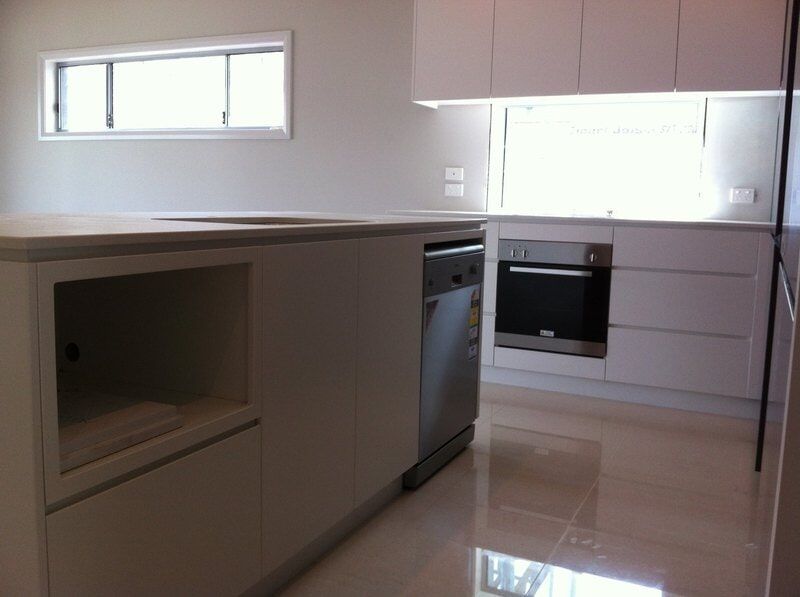 A Kitchen with White Cabinets and Stainless Steel Appliances — Burns Custom Kitchens in Newcastle, NSW