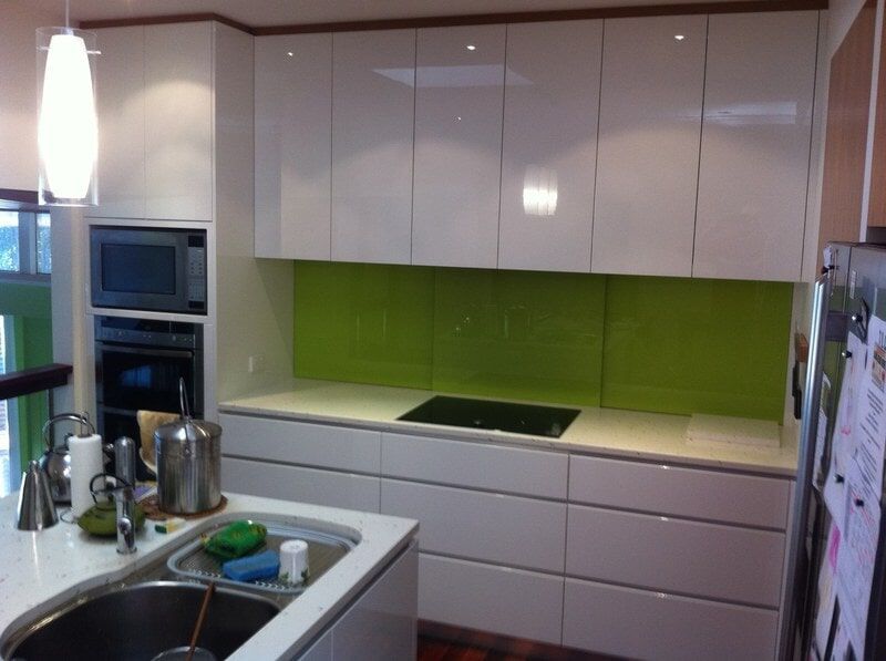 A Kitchen with White Cabinets and Green Counter Tops — Burns Custom Kitchens in Newcastle, NSW