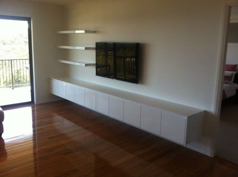 A Living Room with A Flat Screen Tv on The Wall — Burns Custom Kitchens in Newcastle, NSW